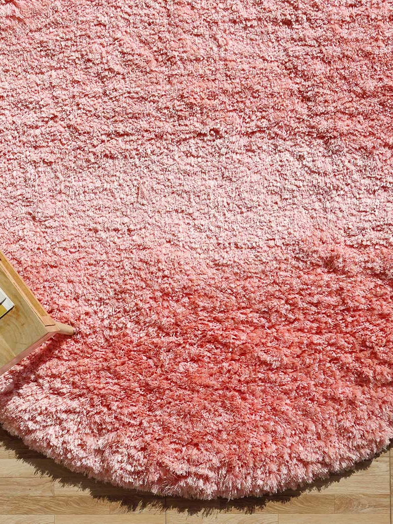 Side close-up highlighting the plush texture and the thick, comforting pile of the pink irregular rug.