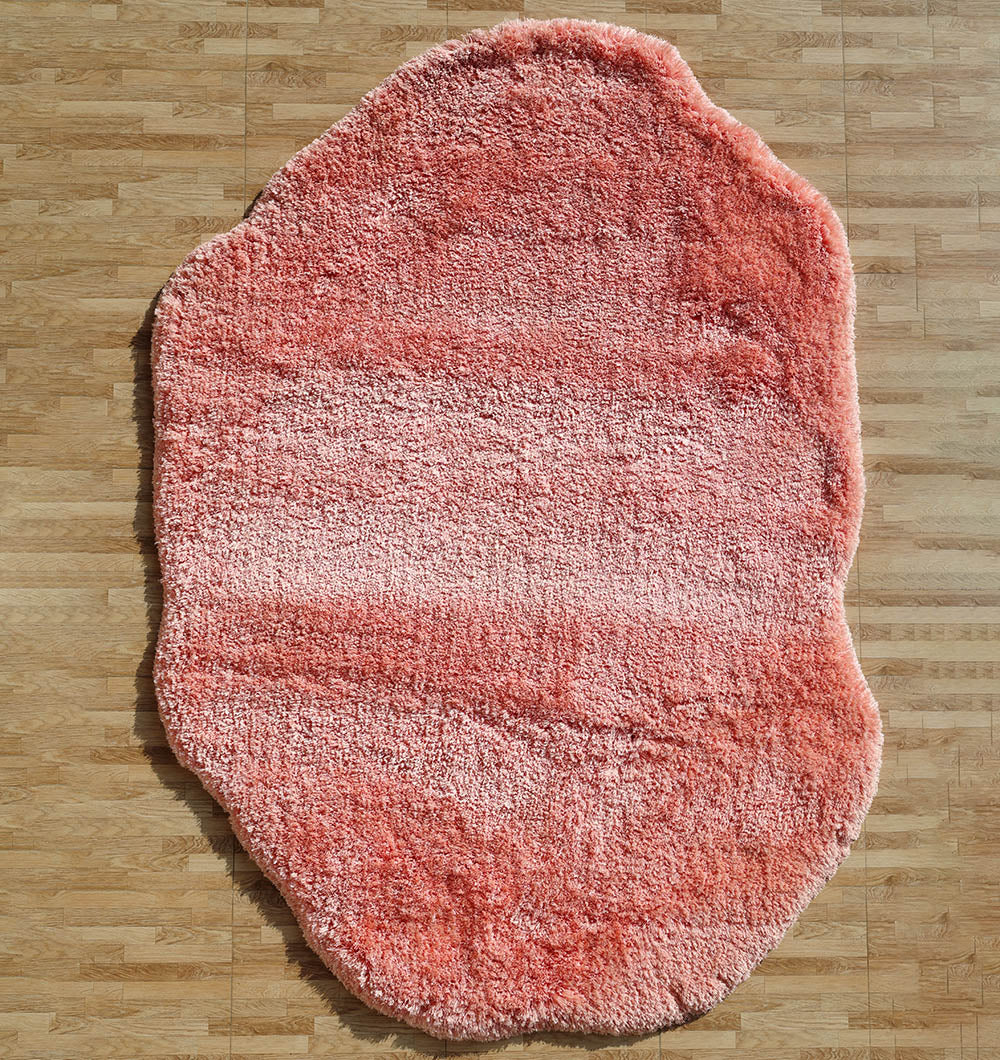 Irregular pink color plush rug, featuring a modern shaggy design for superior softness and unique style.
