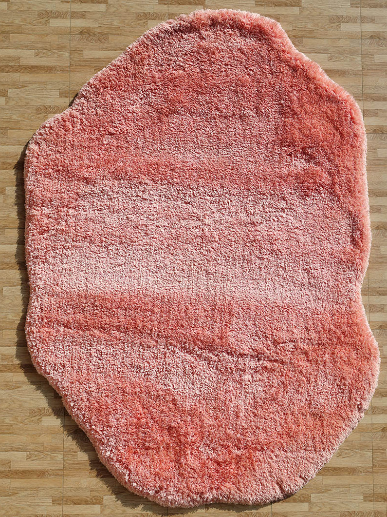 Irregular pink color plush rug, featuring a modern shaggy design for superior softness and unique style.