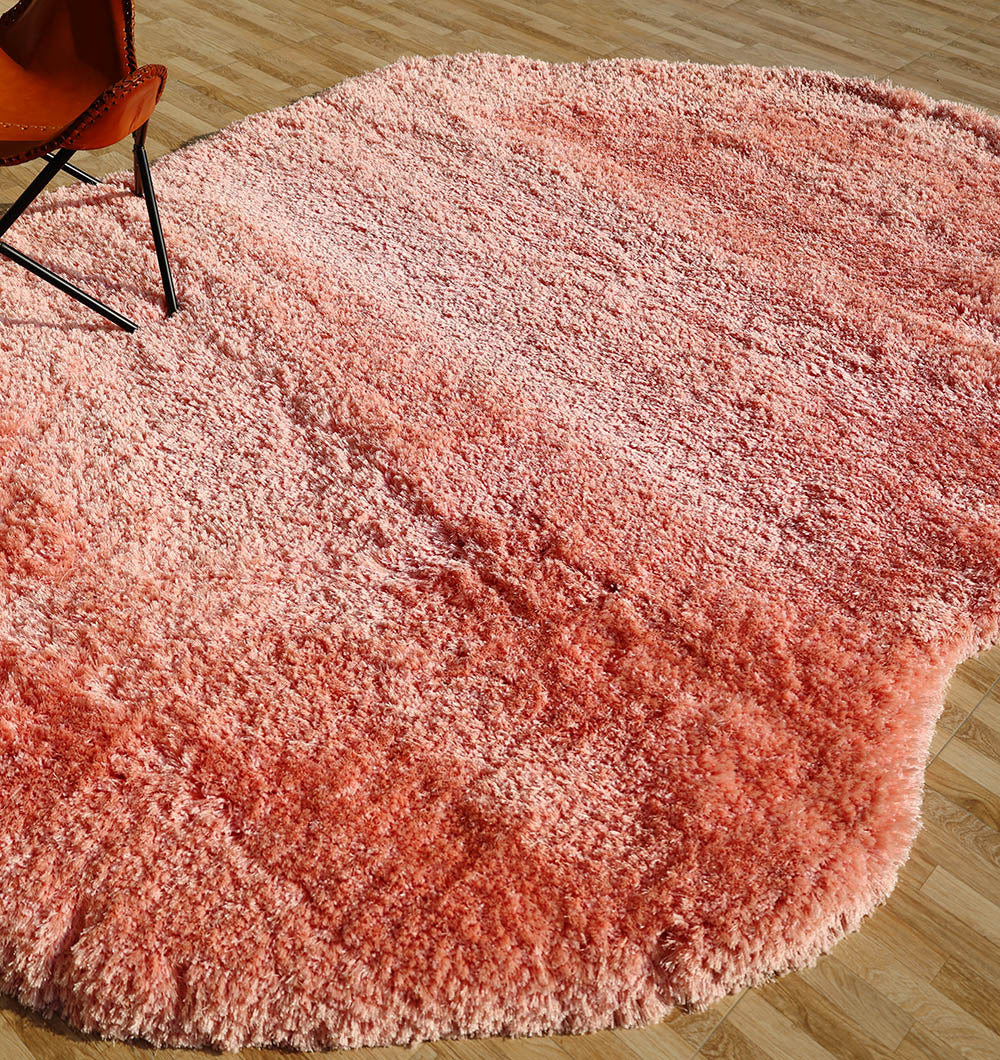 Side view of the vibrant pink irregular rug, demonstrating the warmth and cozy feel of the thick shaggy pile.