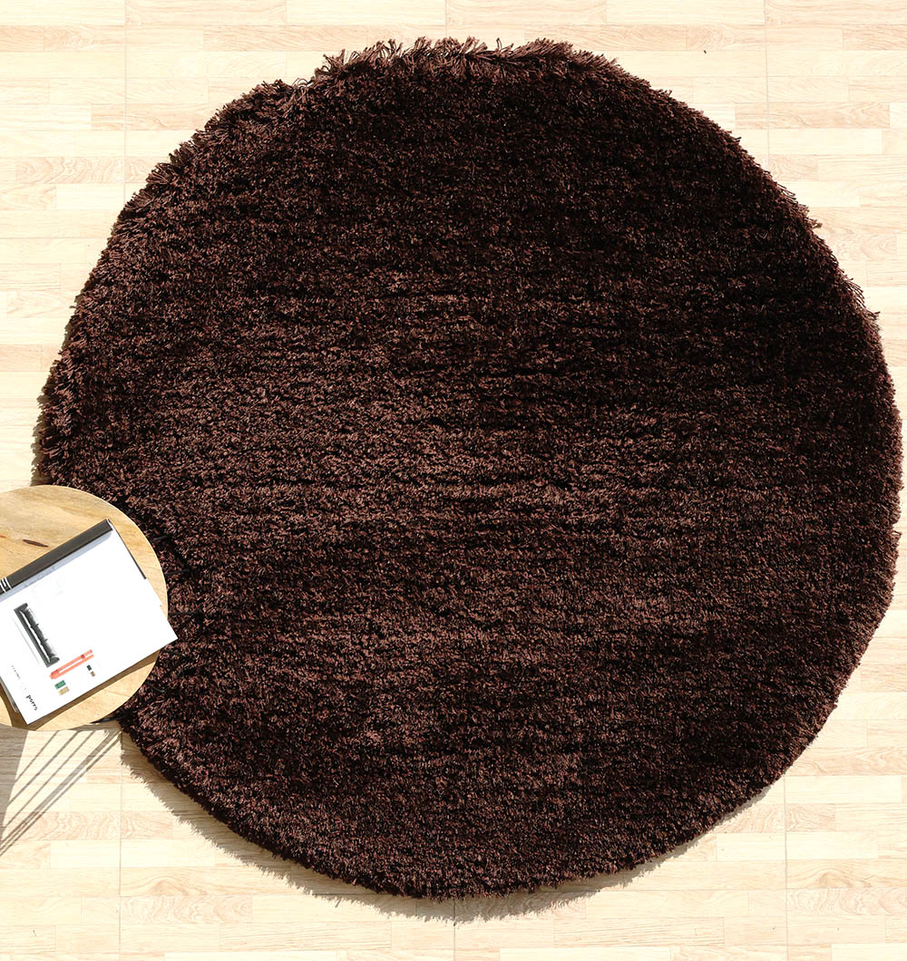Thick shaggy irregular shape rug in dark brown, a soft plush carpet with a unique design for the bedroom.