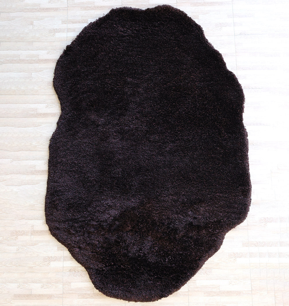 Main product image of the irregular dark brown shaggy rug, the perfect handmade addition to your bedroom or living area.