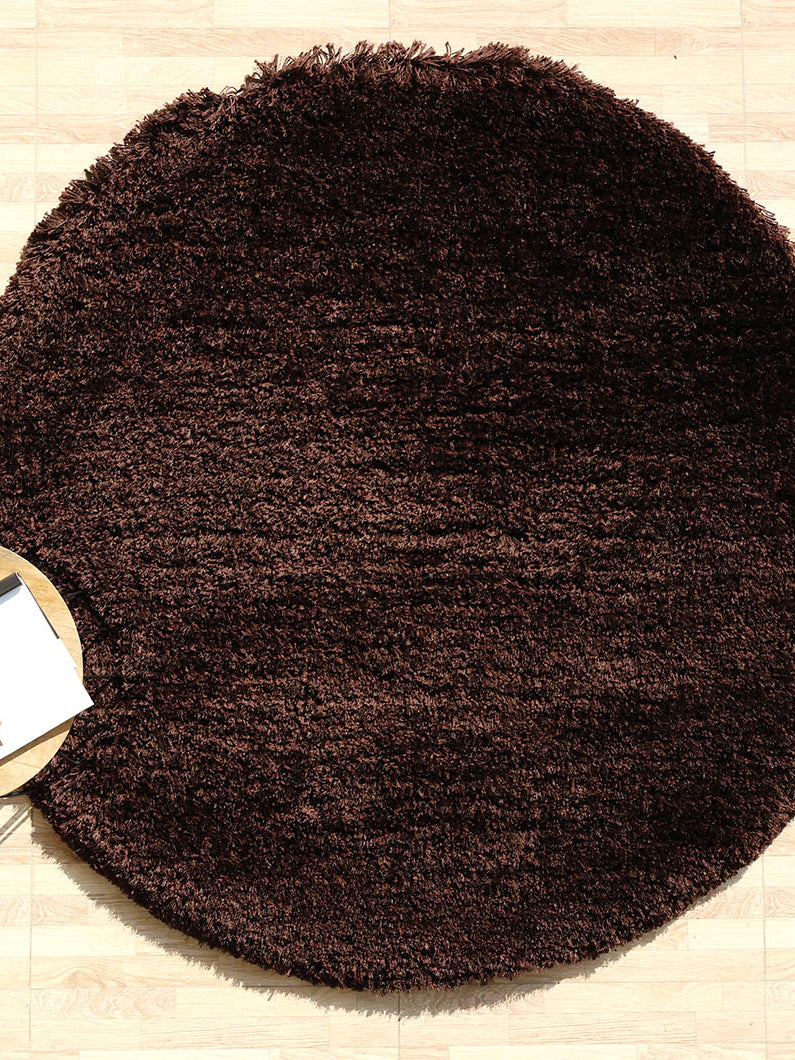 Thick shaggy irregular shape rug in dark brown, a soft plush carpet with a unique design for the bedroom.