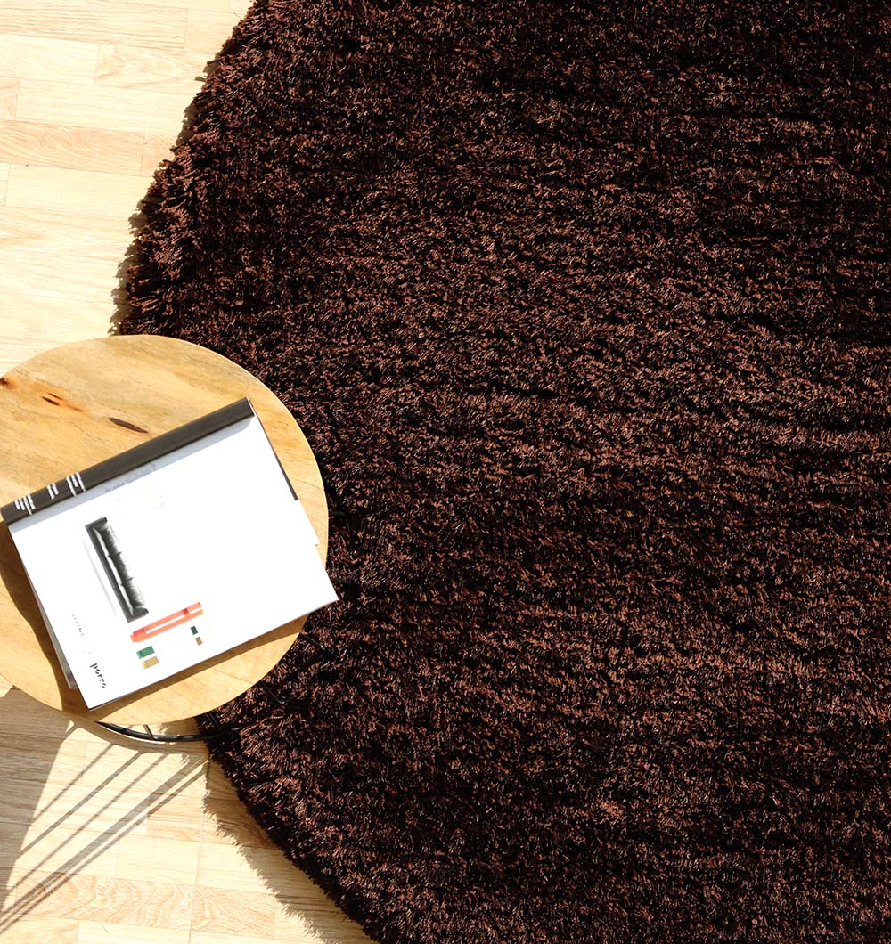 Detailed side view emphasizing the quality and robust weave of the handmade round rug's edge.