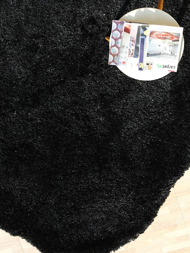 Overhead shot showing the unique irregular shape and thick shaggy pile, seamlessly blending into the contemporary space.