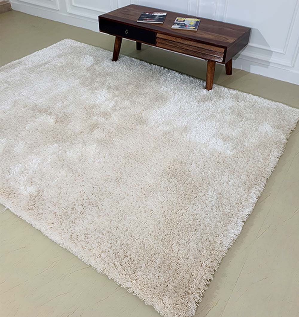 Rectangular grey shaggy carpet covering a bedroom floor, providing a soft texture and easy-care shag surface.