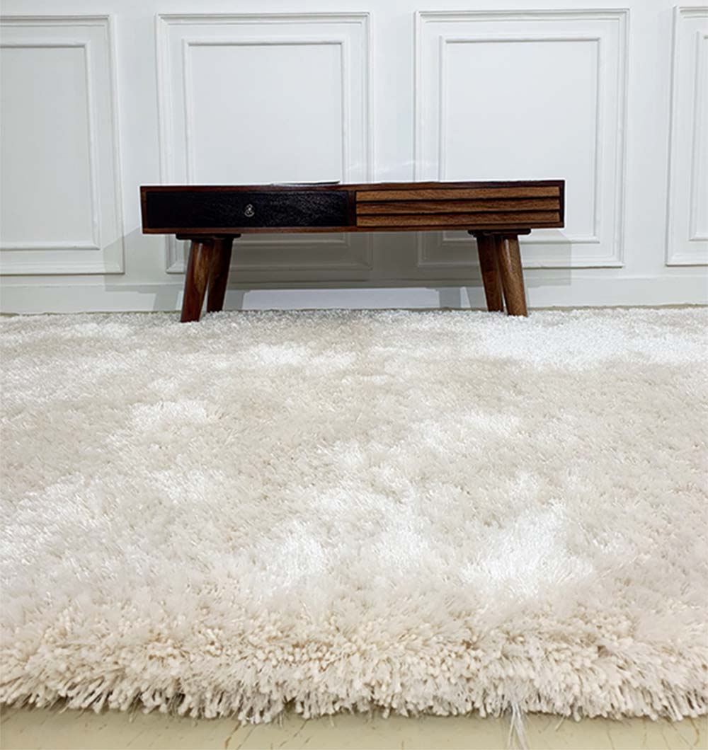 Full view of the rectangular grey shaggy rug in a home space, highlighting its durable construction and thick carpet feel.