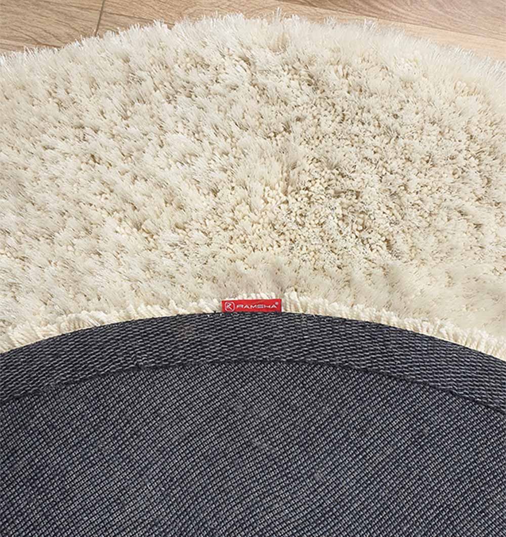 Backside of the grey shaggy rug, confirming the durable construction and secure backing of the synthetic fiber blend.