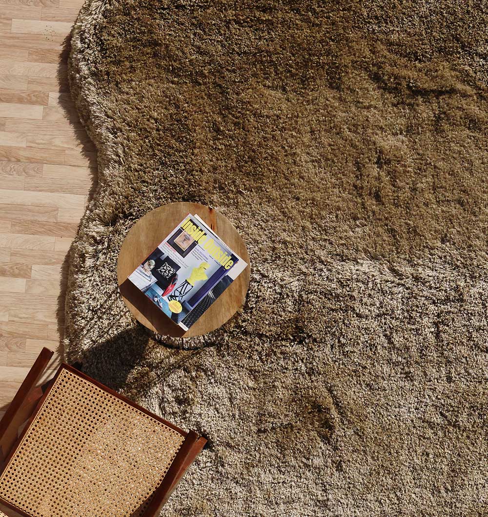 Overhead view emphasizing the warmth and plush texture of the brown carpet, creating a cozy and inviting atmosphere.