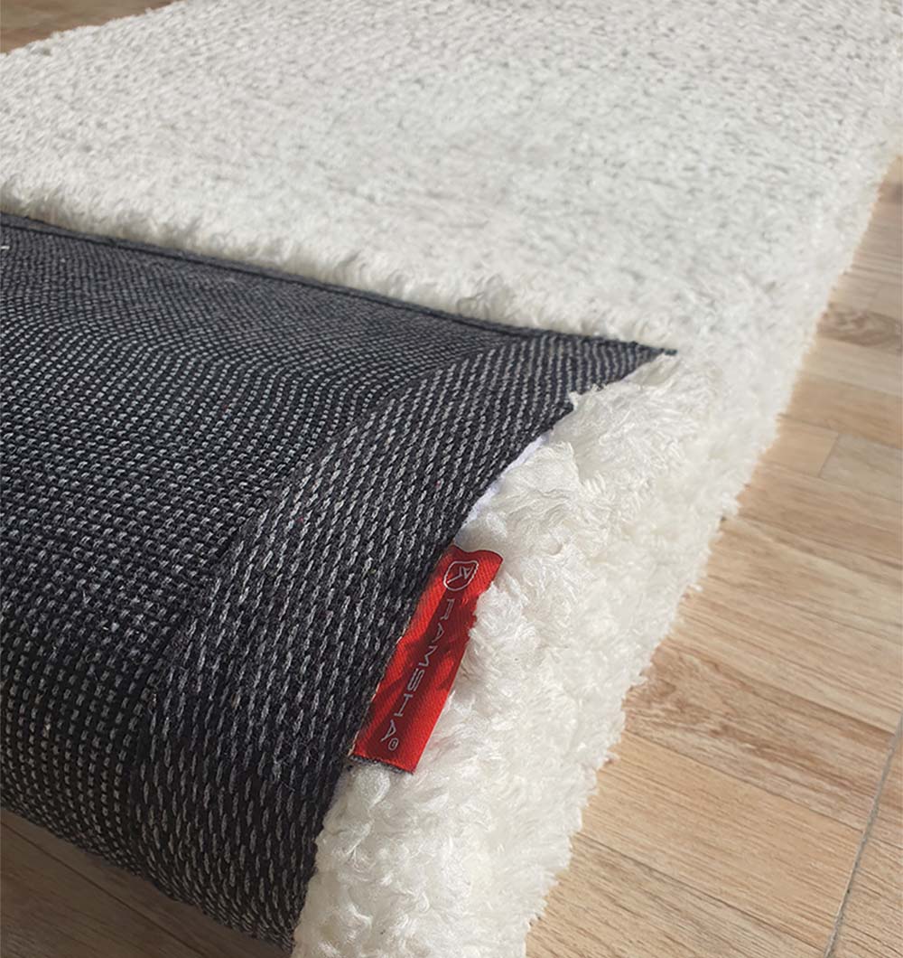 Backside of the rectangle white shaggy rug, confirming the robust handmade construction and lasting quality.