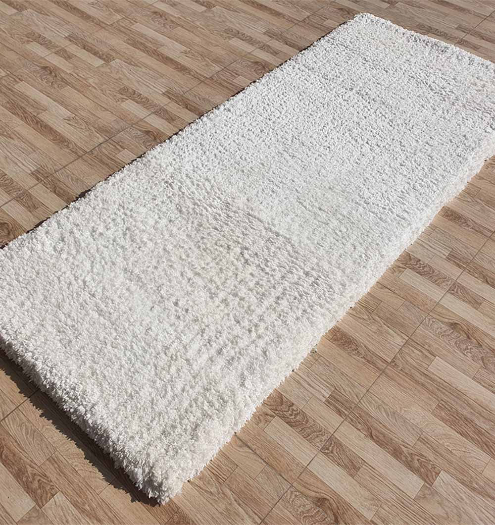 Side angle of the white shaggy runner rug, showcasing its thick pile and soft plush texture for hallways or entryways.