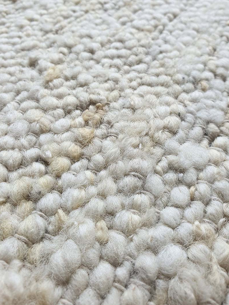 Close-up detailing the distinct woven texture and natural fibers of the 90% wool and 10% cotton blend.