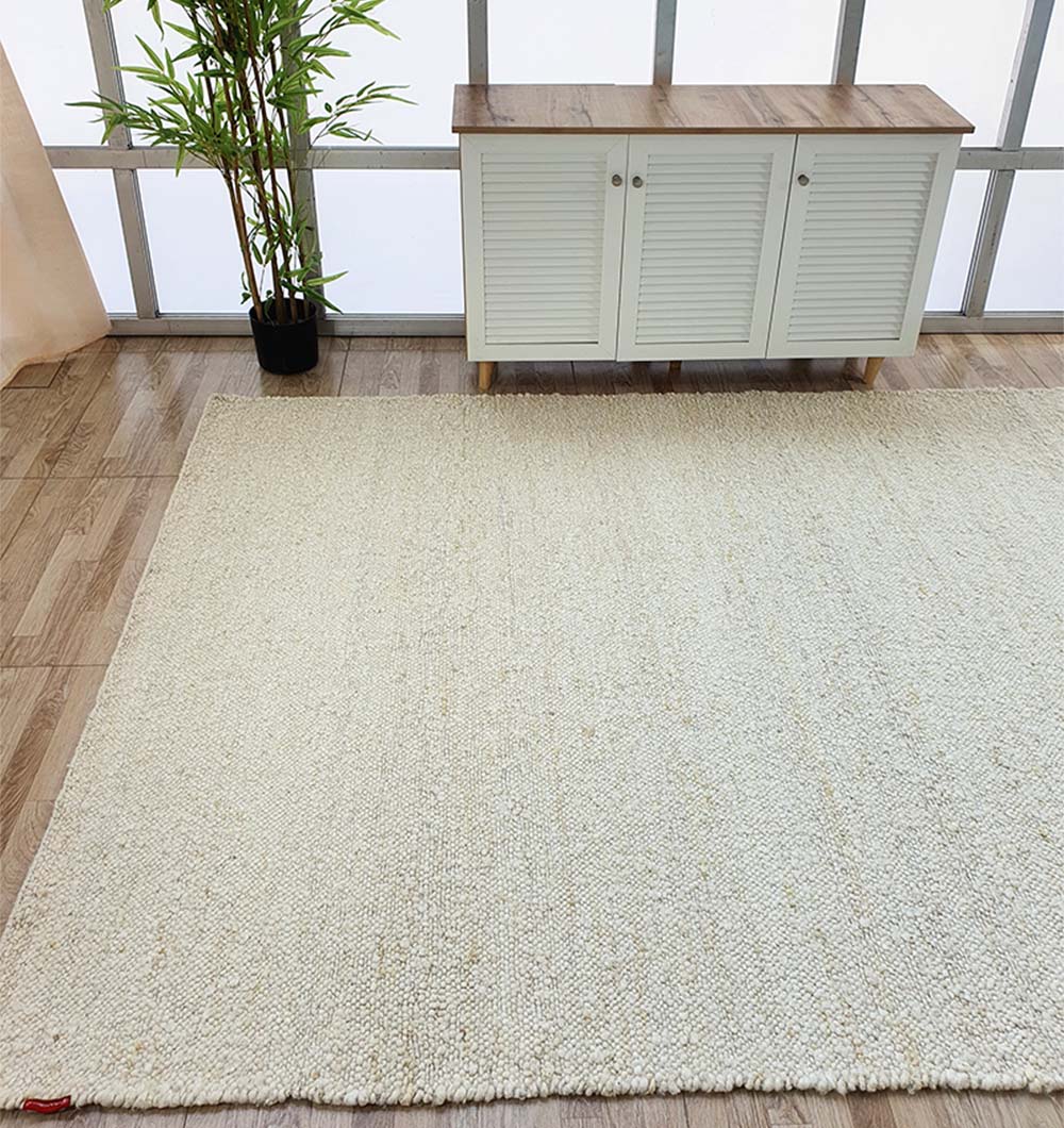 Front view of the large rectangular off-white woven rug, serving as a versatile neutral backdrop in the home decor.