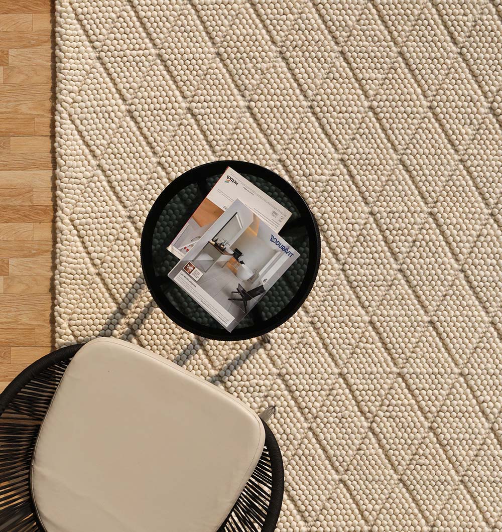 Versatile wool and cotton area rug anchoring a contemporary living room with a natural color palette.