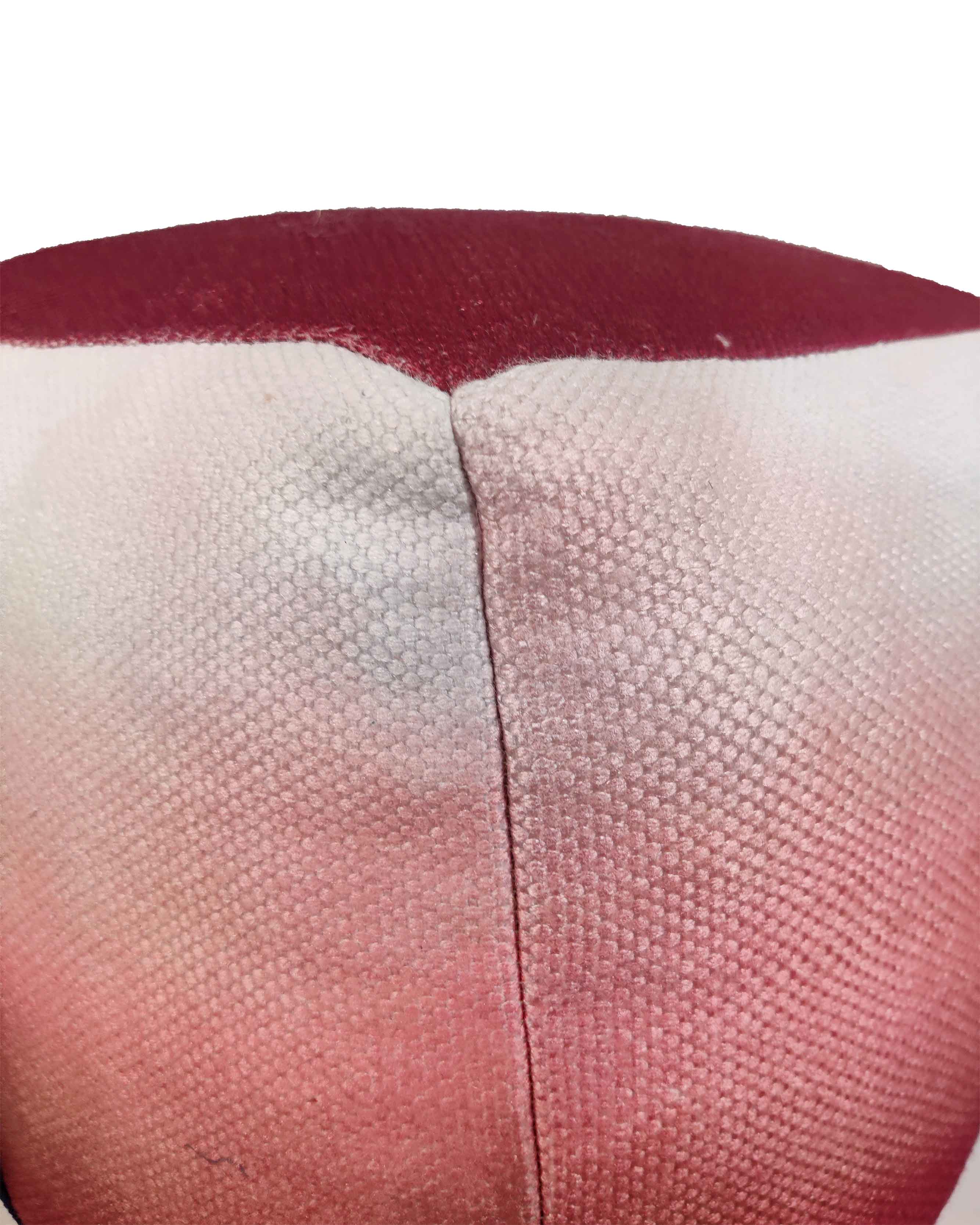 Close-up of red pouf showing vibrant woven polyester-cotton gradient texture