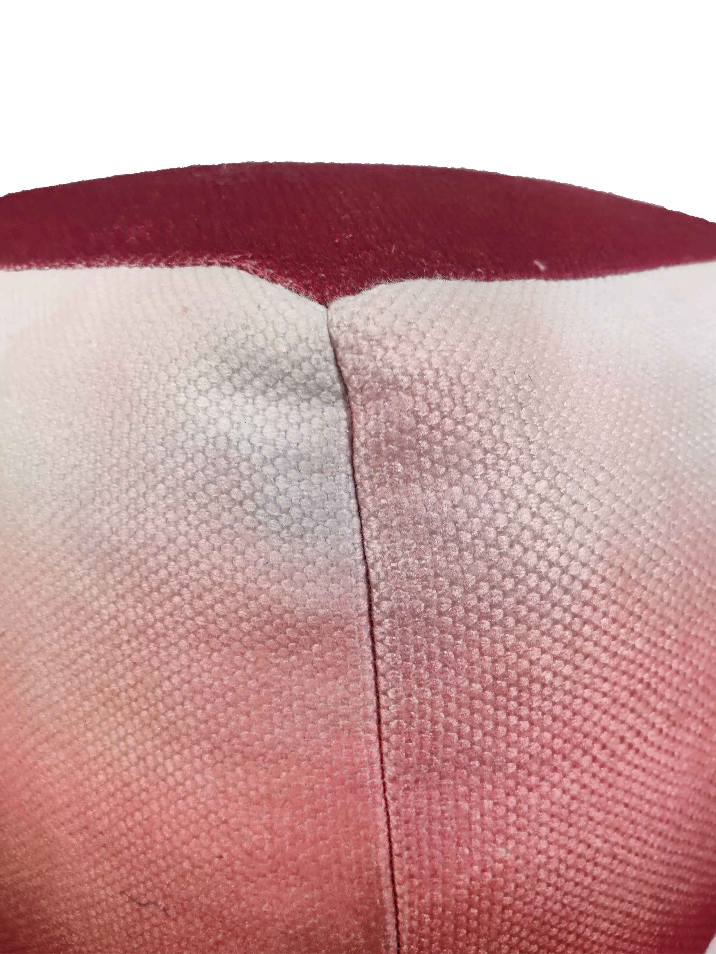 Close-up of red pouf showing vibrant woven polyester-cotton gradient texture