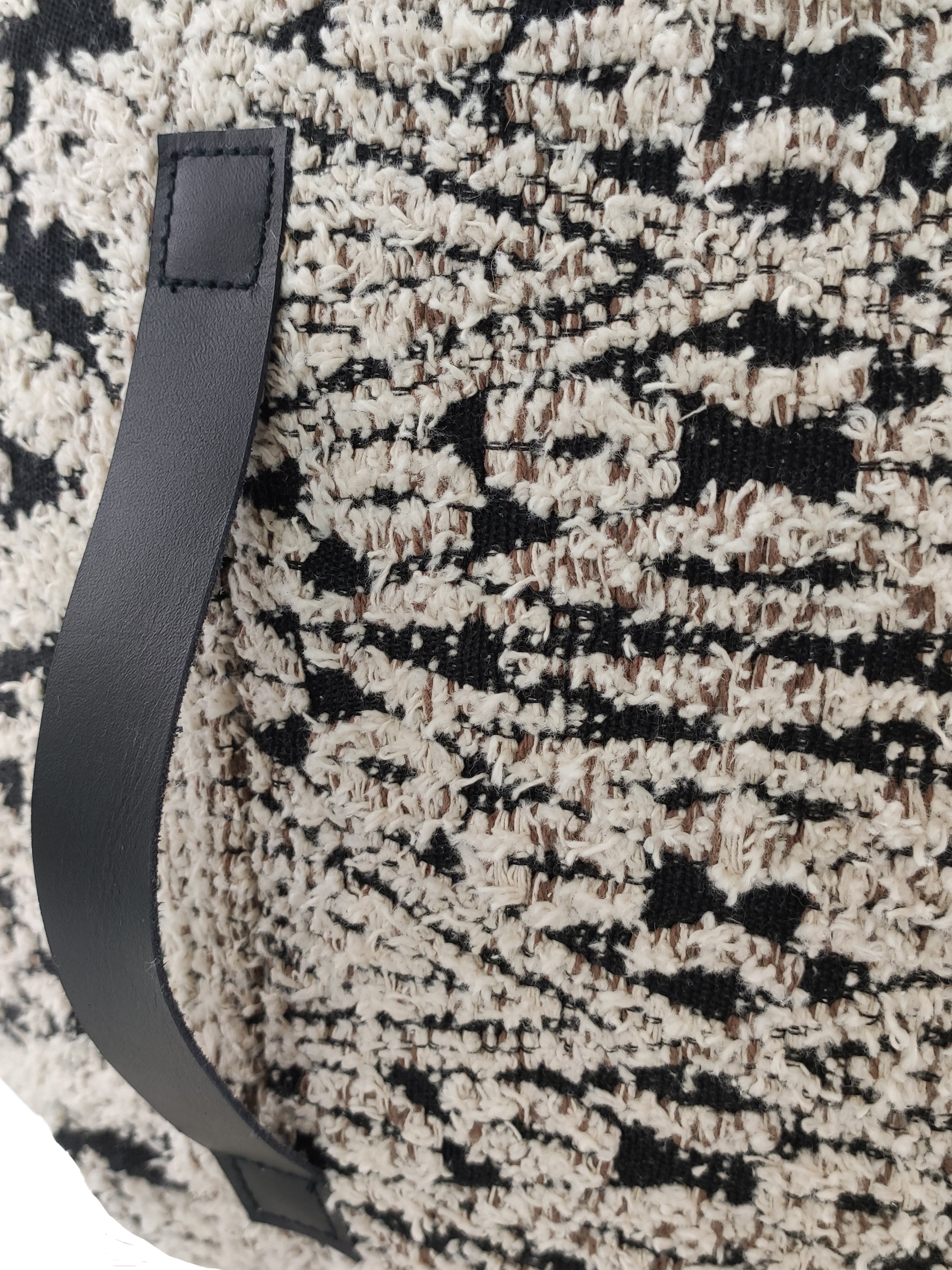 Close-up of black & white cotton pouf showing soft woven texture and handle